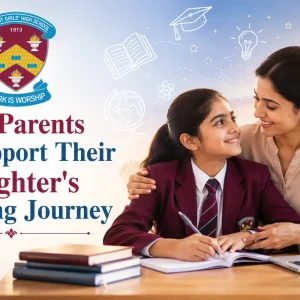 Mohter sitting with her daughter while she is studying